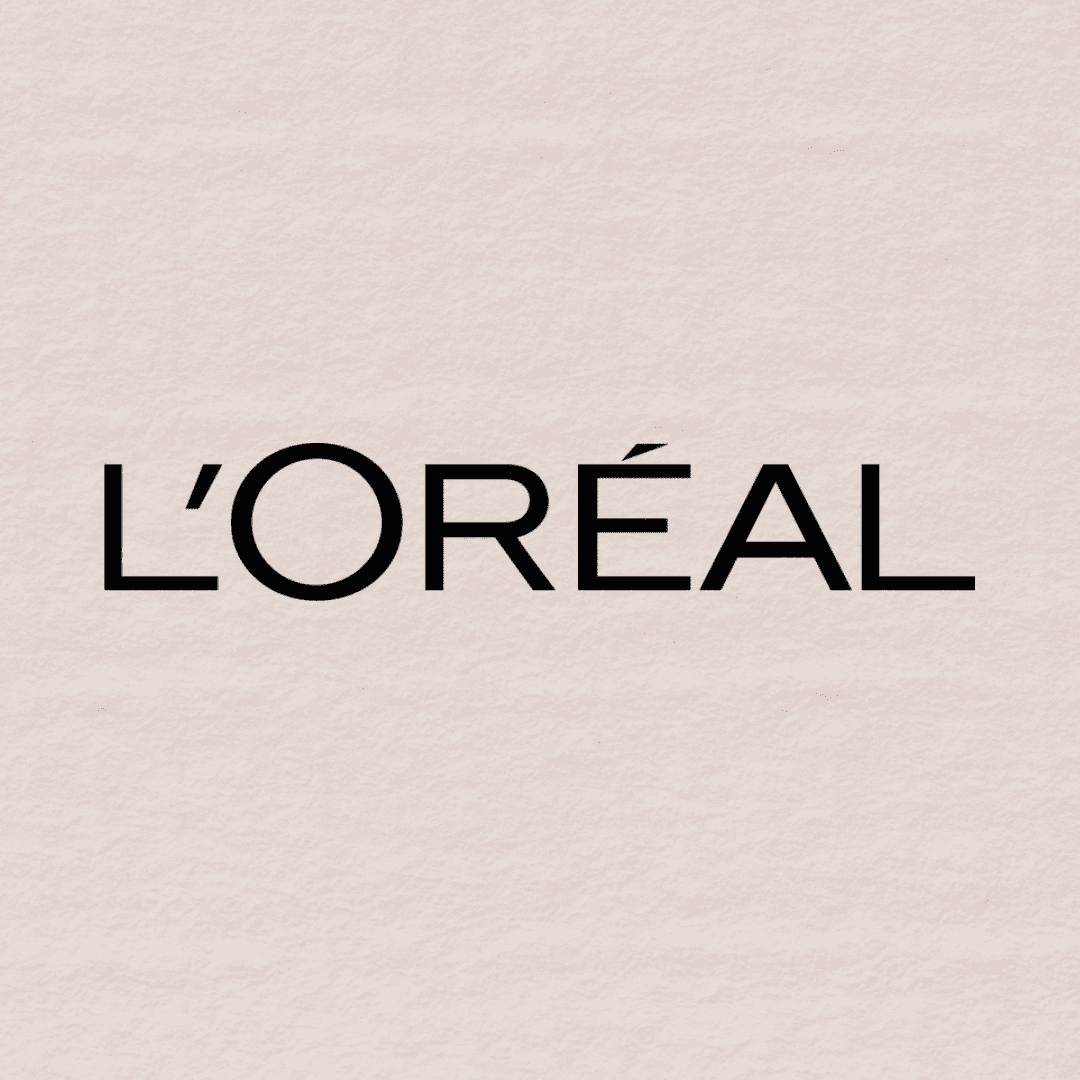 L'Oréal logo on a textured beige background.