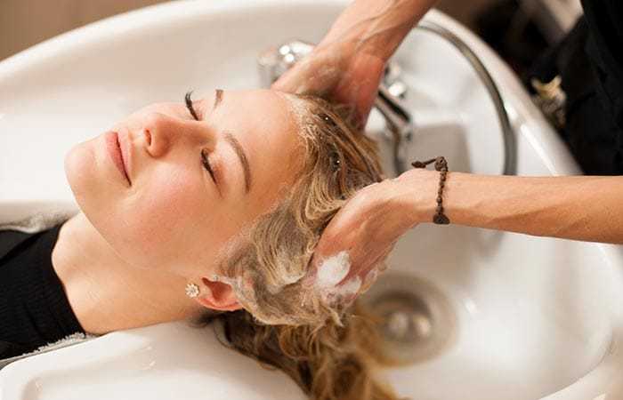 Woman receiving a relaxing hair wash at a salon.